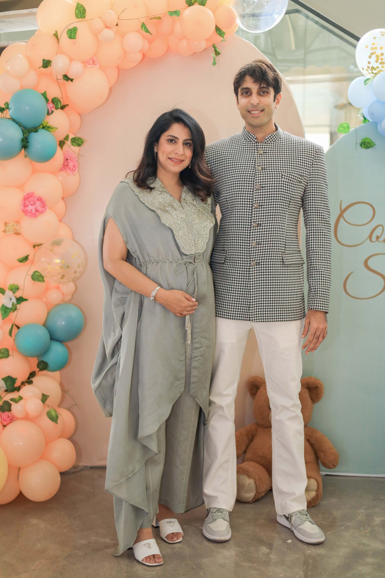 Expectant couple standing together at the decorated setup