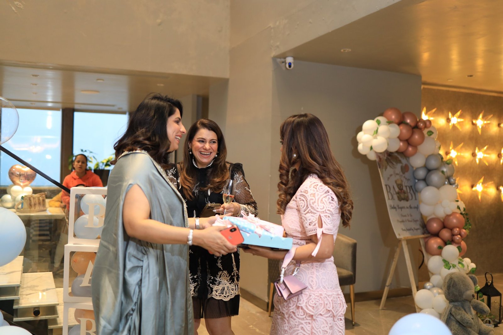 Guests exchanging gifts with the mother-to-be