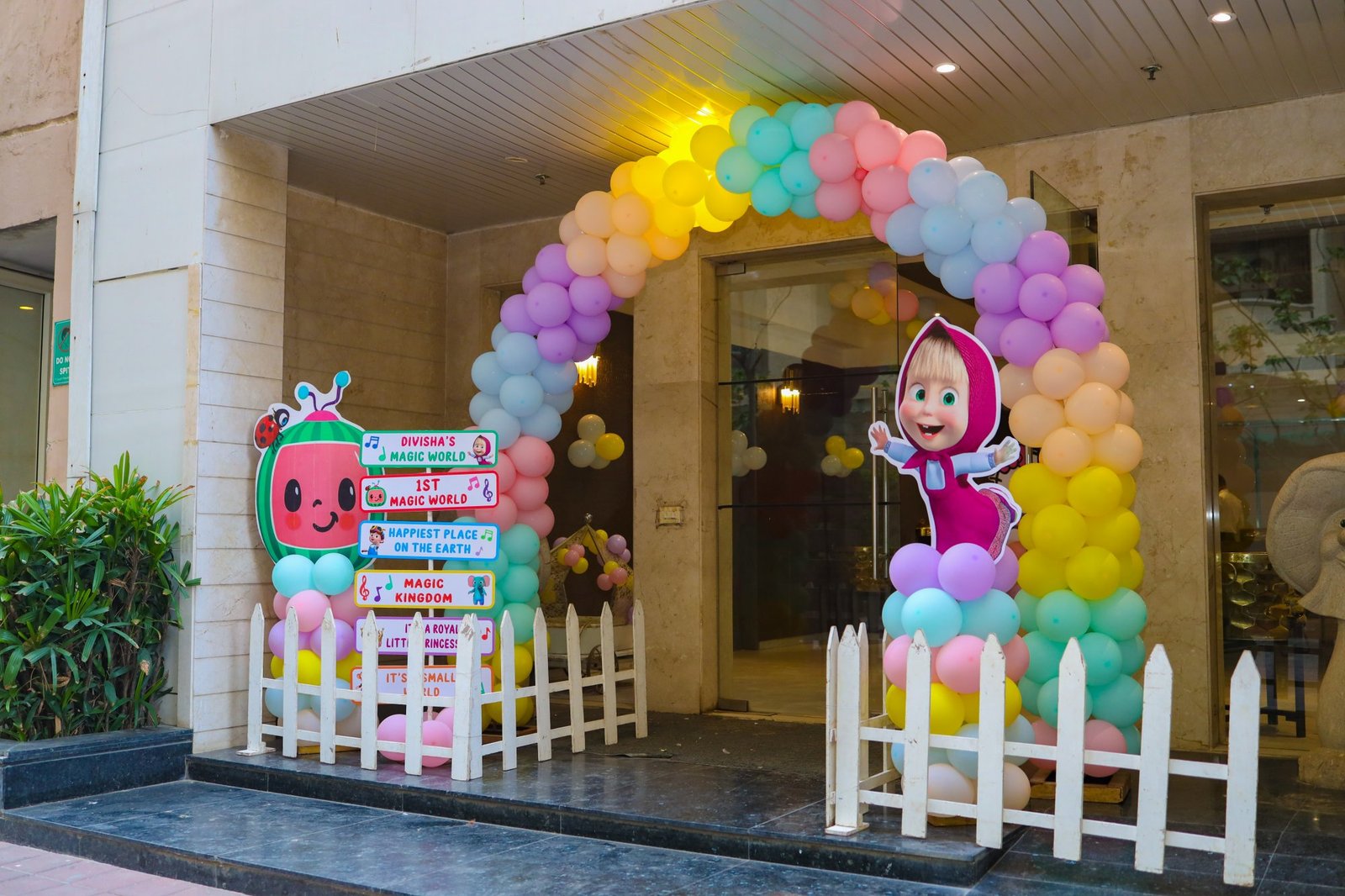 Balloon arch framing the entrance to a birthday party