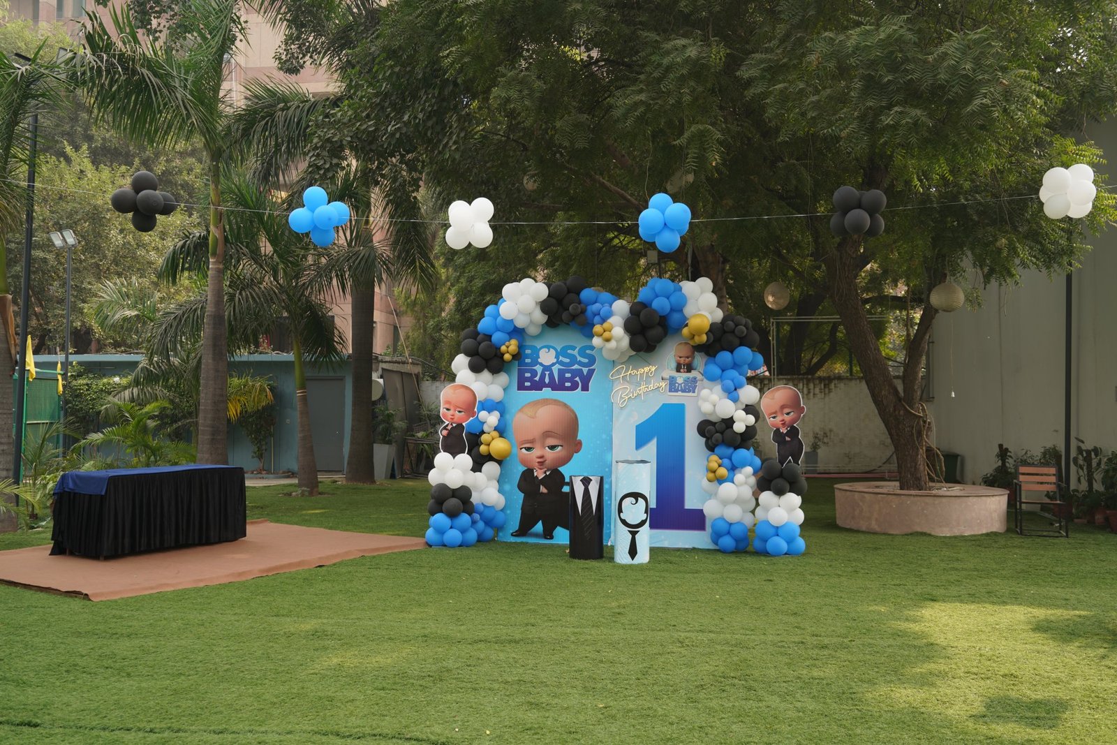 Outdoor party setup with balloons and seating on the lawn