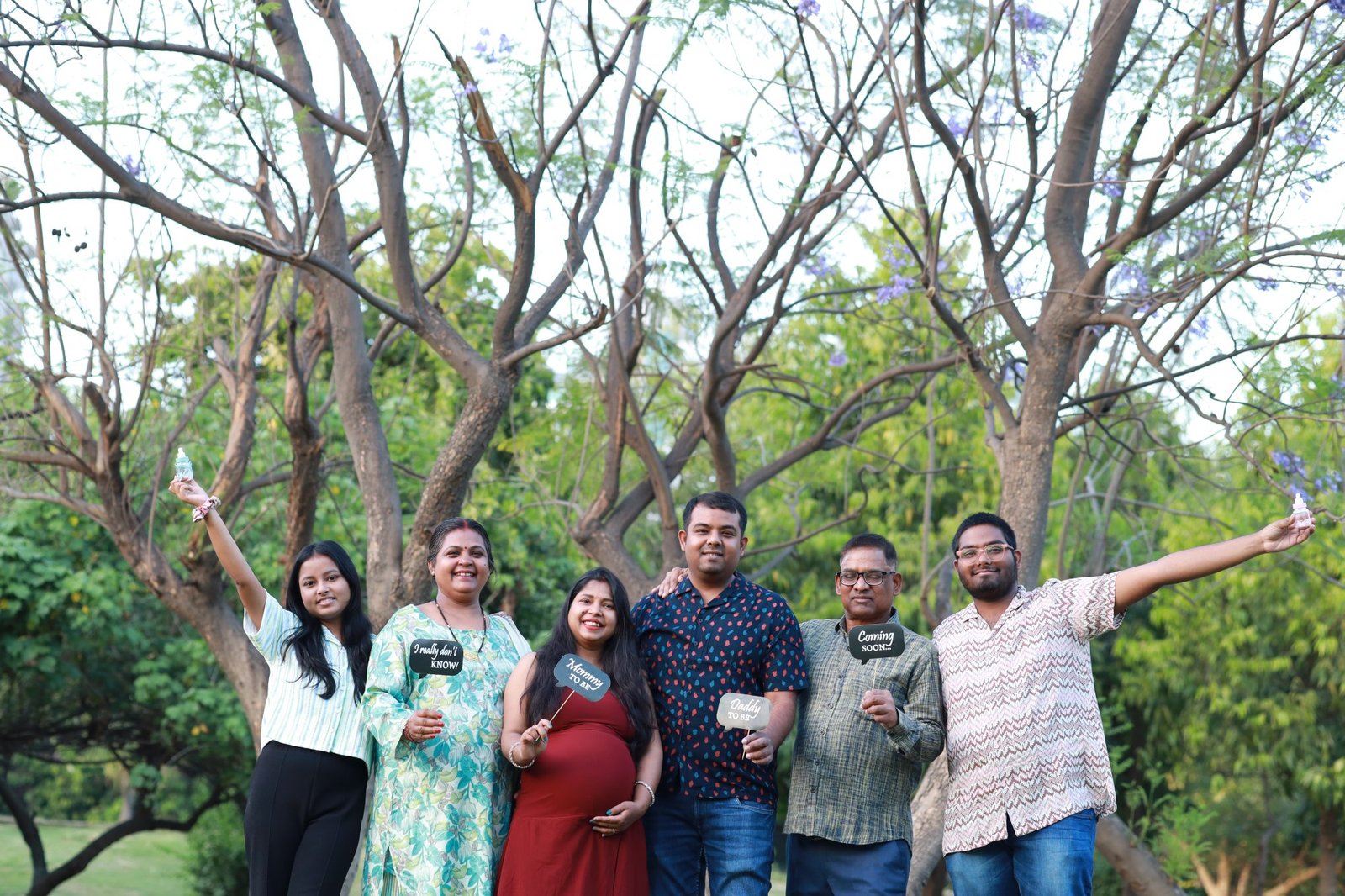 Family group celebrating together among bare trees