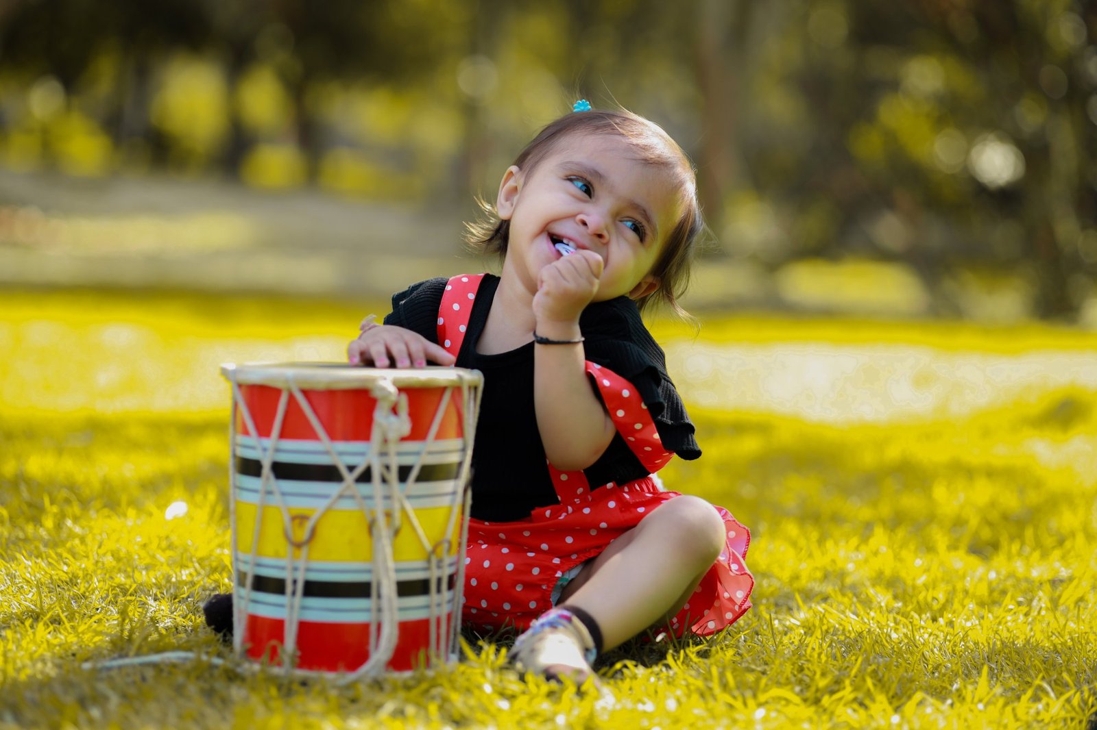 One year old outdoors reaching into a cake set in a basket